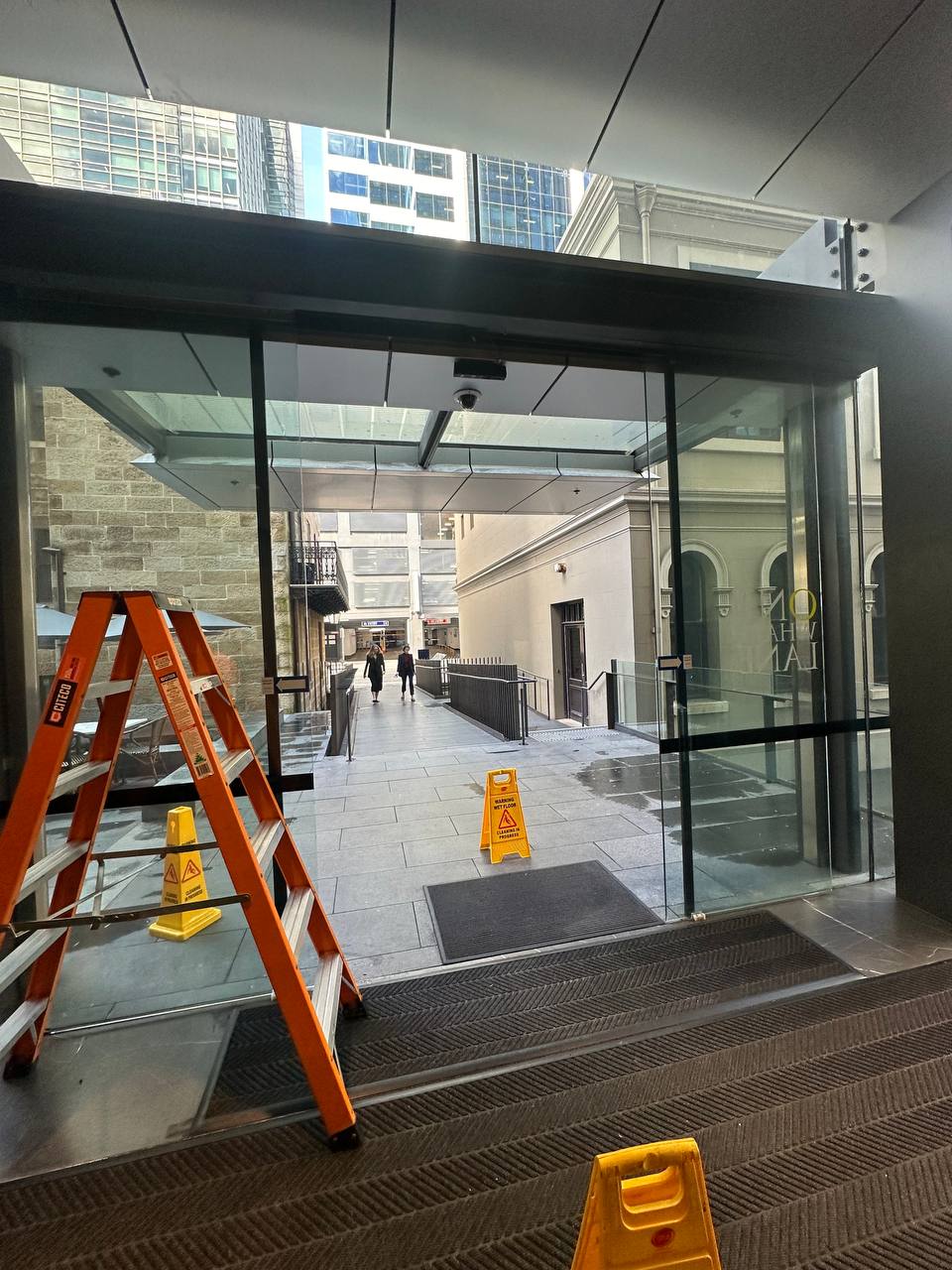 NEWGEN Automation servicing commercial automatic doors at a CBD office building exterior in Sydney